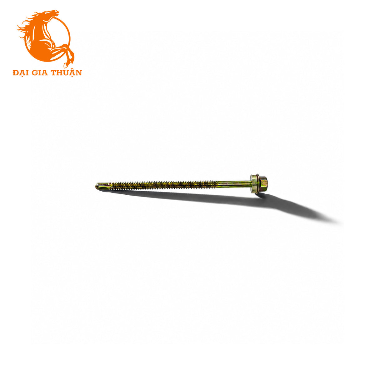 A Vít tôn xà sắt xi mạ vàng ron trắng 100mm with a matching hex nut, finished in a gold-toned metallic coating, shown on a plain white background with a soft shadow. The orange logo 'DÁI GIA THÚN' is visible in the top-left corner.