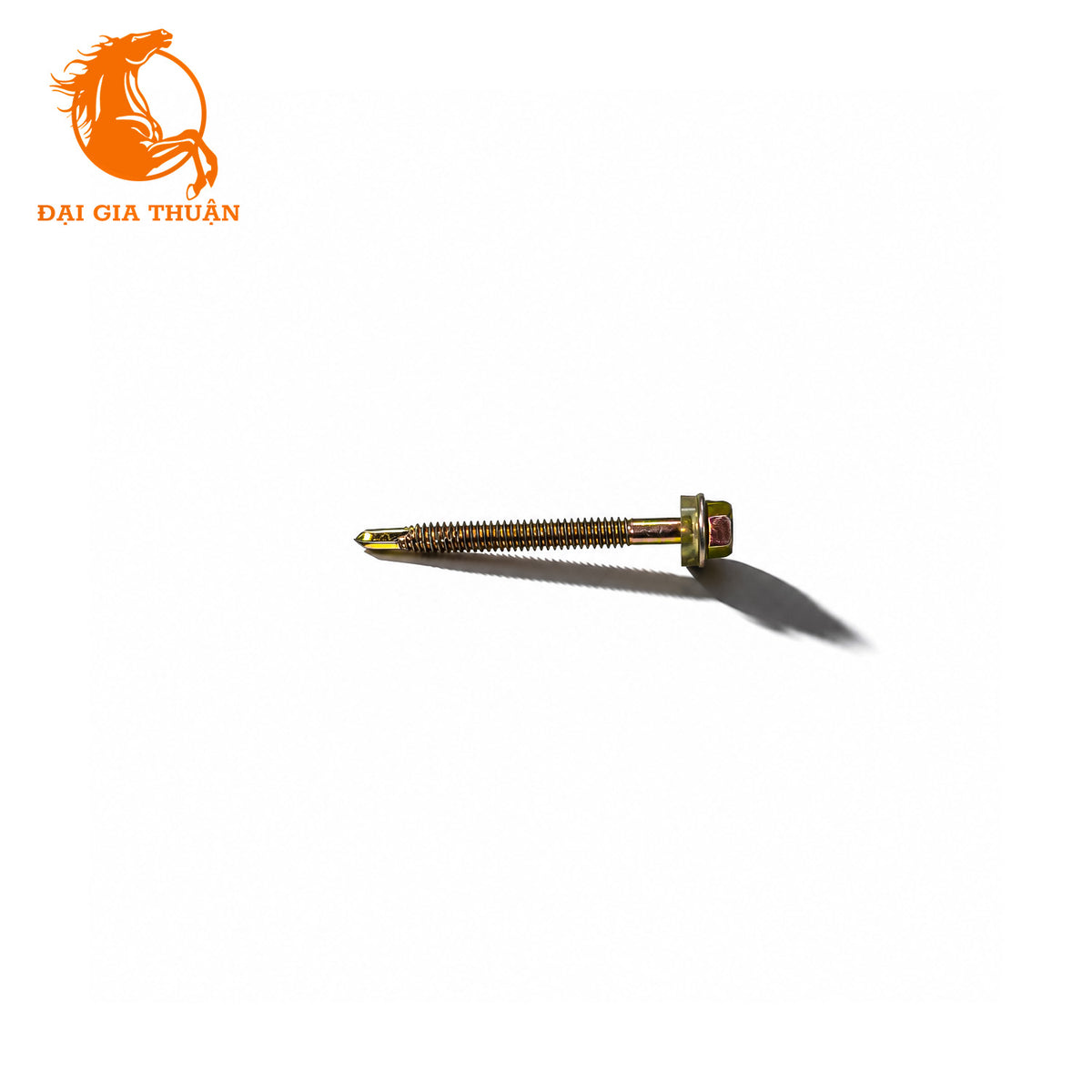 A Vít tôn xà sắt xi mạ vàng ron trắng 60mm with a hex head and a red rubber seal, shown on a plain white background with a cast shadow. The orange logo for 'Đại Gia Thuận' is visible in the top-left corner.